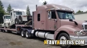 Hauling two Freightliner daycab trucks.